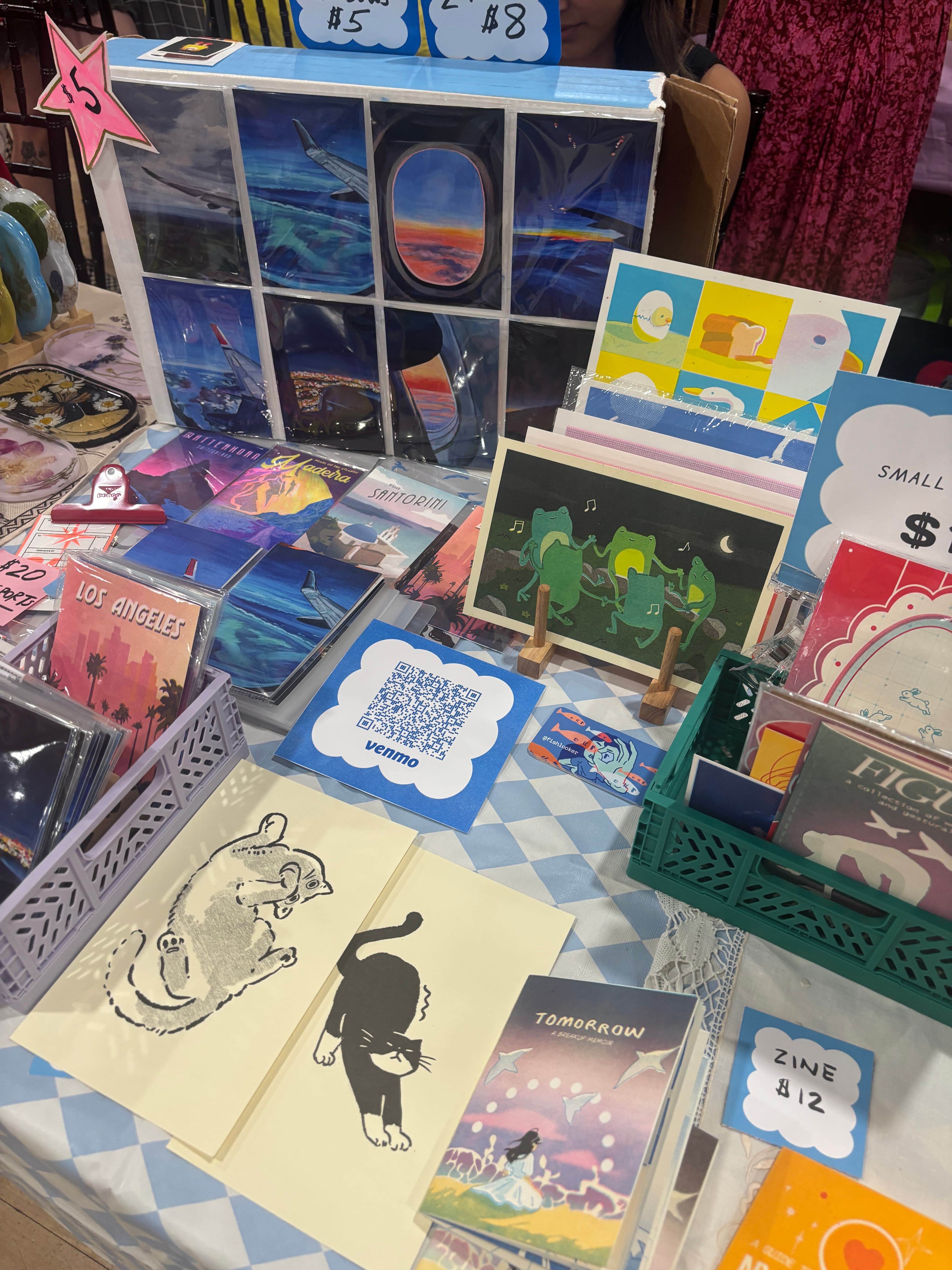 table spread of prints, zines, and stickers